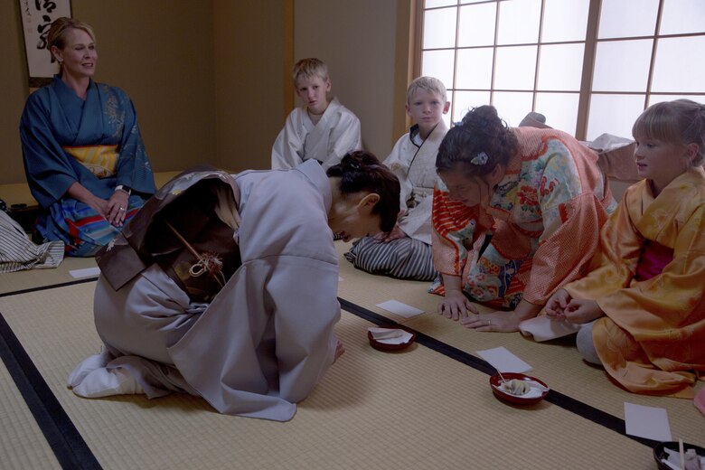An instructor bows to Beata Foldenauer, right, while serving mochi, a Japanese confection made from rice flour, during a Japanese Tea Ceremony Class at the Yayoi Kimono Shop and Cultural School Sept. 17 in Naha, Okinawa, Japan. The class gave Status of Forces Agreement members the opportunity to dress in traditional Japanese garments and learn about Japanese culture firsthand. During the class, instructors who hosted the event dressed the SOFA personnel in kimonos and taught them the customs and courtesies that accompany visiting a Japanese home. The students learned how to properly receive tea and refreshments and how to prepare the matcha, which is a powdered green tea commonly served at tea ceremonies. Foldenauer is a Bekescsaba, Hungary, native.