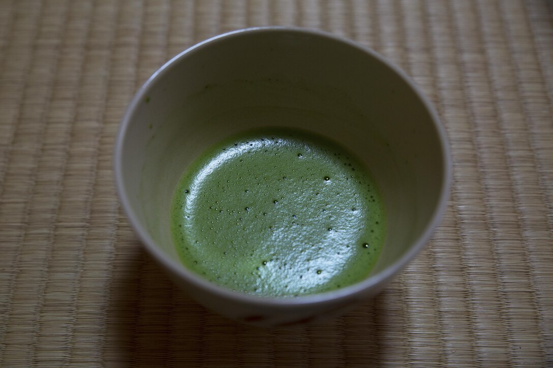A bowl of matcha rests on a tatami mat at the Yayoi Kimono Shop and Cultural School during a Japanese Tea Ceremony Class Sept. 17 in Naha, Okinawa, Japan. The class provided Status of Forces Agreement personnel with the opportunity to experience Japanese traditions firsthand. Matcha is a powdered green tea that is customarily served during Japanese tea ceremonies. The students learned how to politely partake of tea and refreshments and how to prepare, present and serve the matcha.