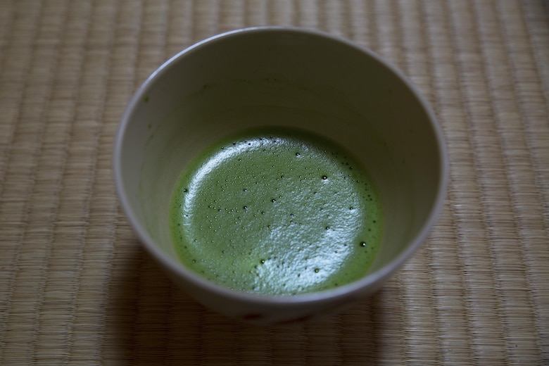A bowl of matcha rests on a tatami mat at the Yayoi Kimono Shop and Cultural School during a Japanese Tea Ceremony Class Sept. 17 in Naha, Okinawa, Japan. The class provided Status of Forces Agreement personnel with the opportunity to experience Japanese traditions firsthand. Matcha is a powdered green tea that is customarily served during Japanese tea ceremonies. The students learned how to politely partake of tea and refreshments and how to prepare, present and serve the matcha.