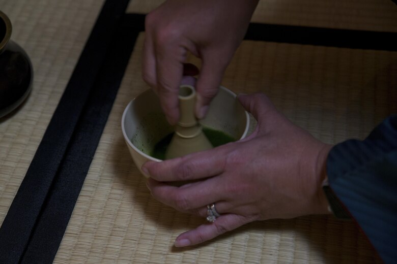 A Status of Forces Agreement member prepares matcha, a Japanese powdered green tea, during a Japanese Tea Ceremony Class at the Yayoi Kimono Shop and Cultural School Sept. 17 in Naha, Okinawa, Japan. Preparing the matcha was the final step in the class that focused on preparation, presentation and etiquette while serving guests.