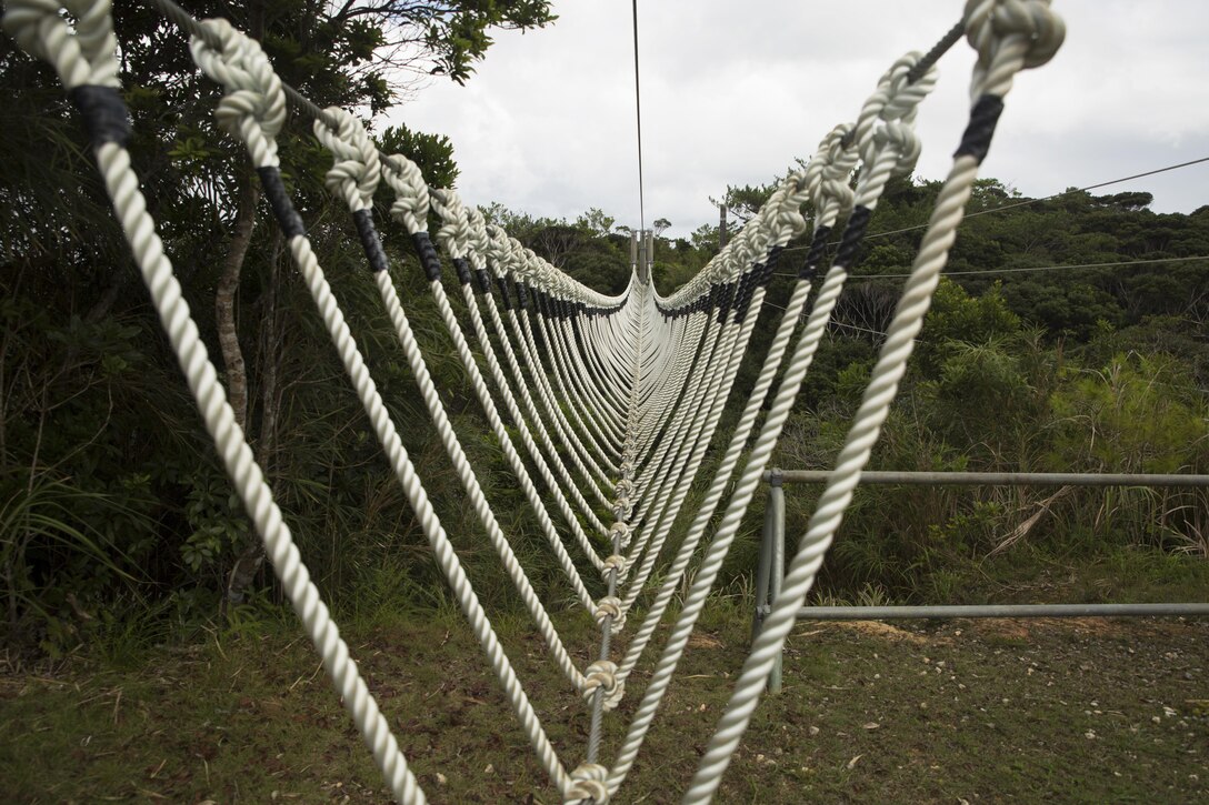 A three-strand obstacle sprawls over an open valley at the Jungle Warfare Training Center Sept. 20, 2016 at Jungle Warfare Training Center in Okinawa, Japan. This obstacle is one of the 31 obstacles Marines must navigate during the culminating event of any JWTC course. JWTC is utilized for its harsh terrain and conditions to prepare Marines for operations in the Asia-Pacific Region and stretches over more than 17,000 acres. (U.S. Marine Corps photo by Cpl. Janessa K. Pon)