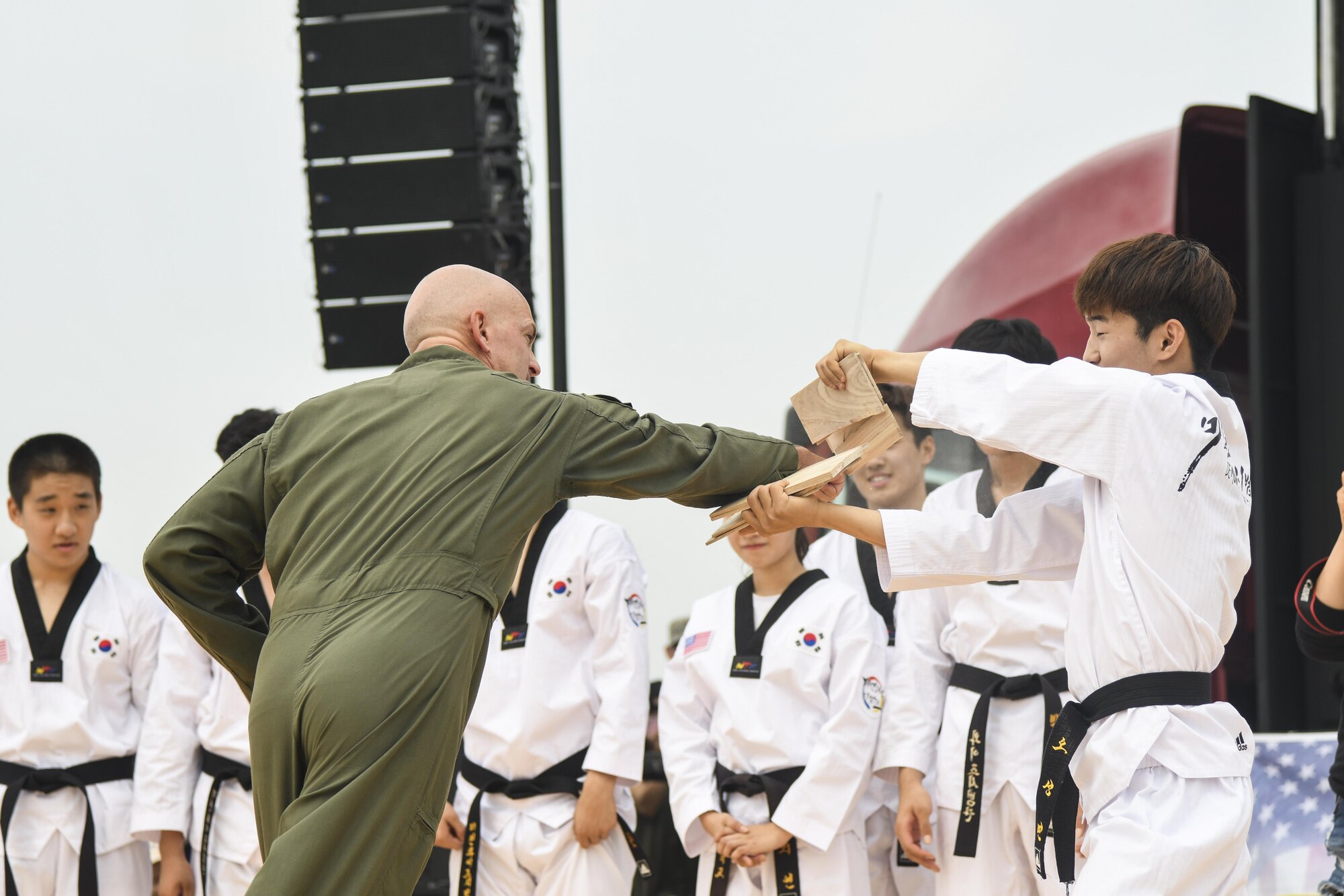 Col. Andrew Hansen, 51st Fighter Wing commander, punches through pieces of board after the Republic of Korea Martial Arts Demonstration Team performed their orchestrated movements during Air Power Day 2016 at Osan Air Base, Republic of Korea, Sept. 25, 2016. Members of Team Osan and the surrounding community participated in events for the air show such as static displays, aircraft takeoffs and aerial demonstrations. (U.S. Air Force photo by Tech. Sgt. Rasheen Douglas)