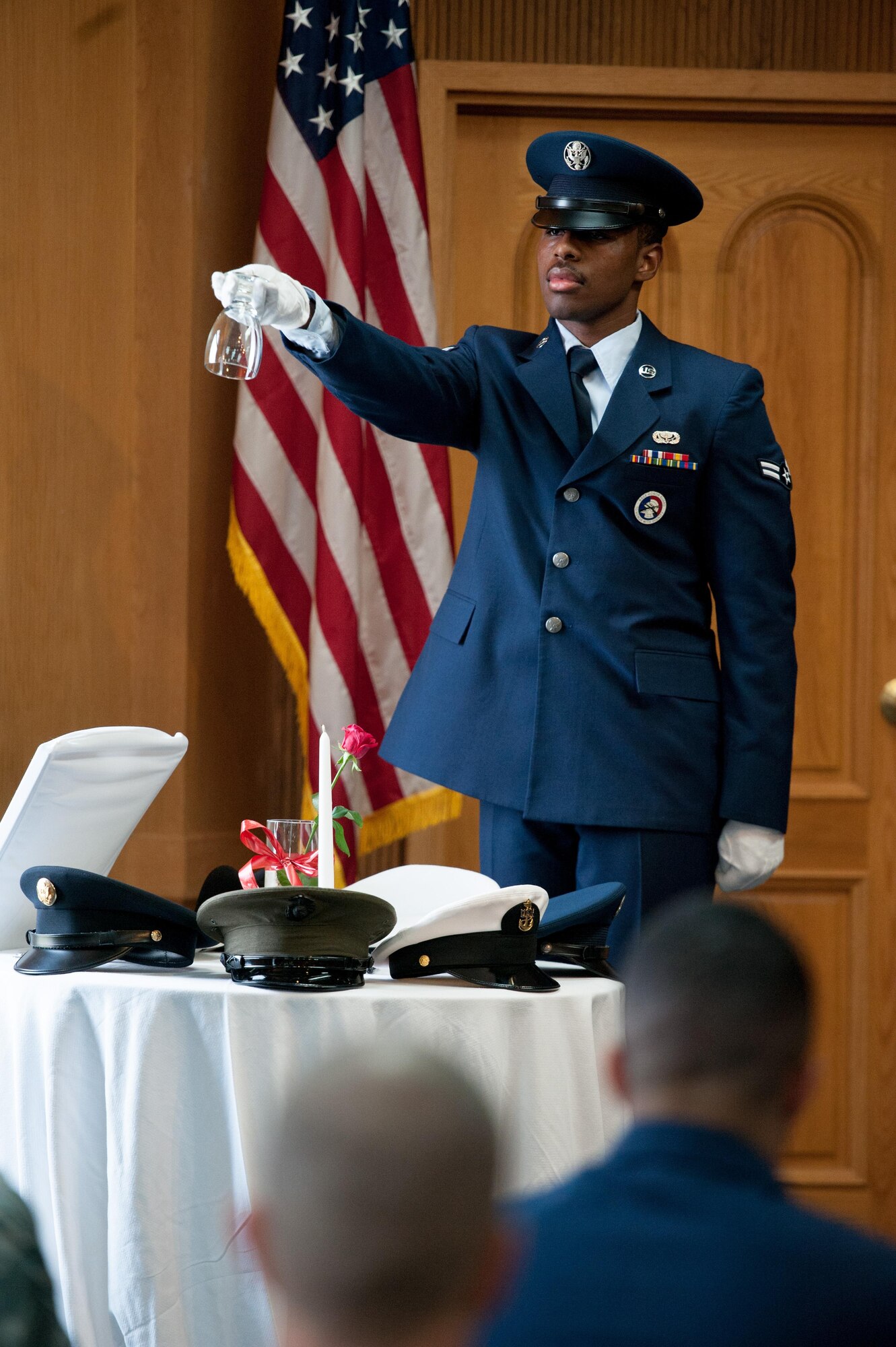 U.S. Air Force Airman 1st Class Colin Jeffers, 51st Force Support Squadron services journeyman, inverts an empty glass during the opening ceremony of a POW/MIA memorial service at Osan Air Base, Republic of Korea, Sept. 15, 2016. The event honors missing service members and the U.S. government’s continued responsibility to locate prisoners of war. (U.S. Air Force photo by Staff Sgt. Jonathan Steffen)