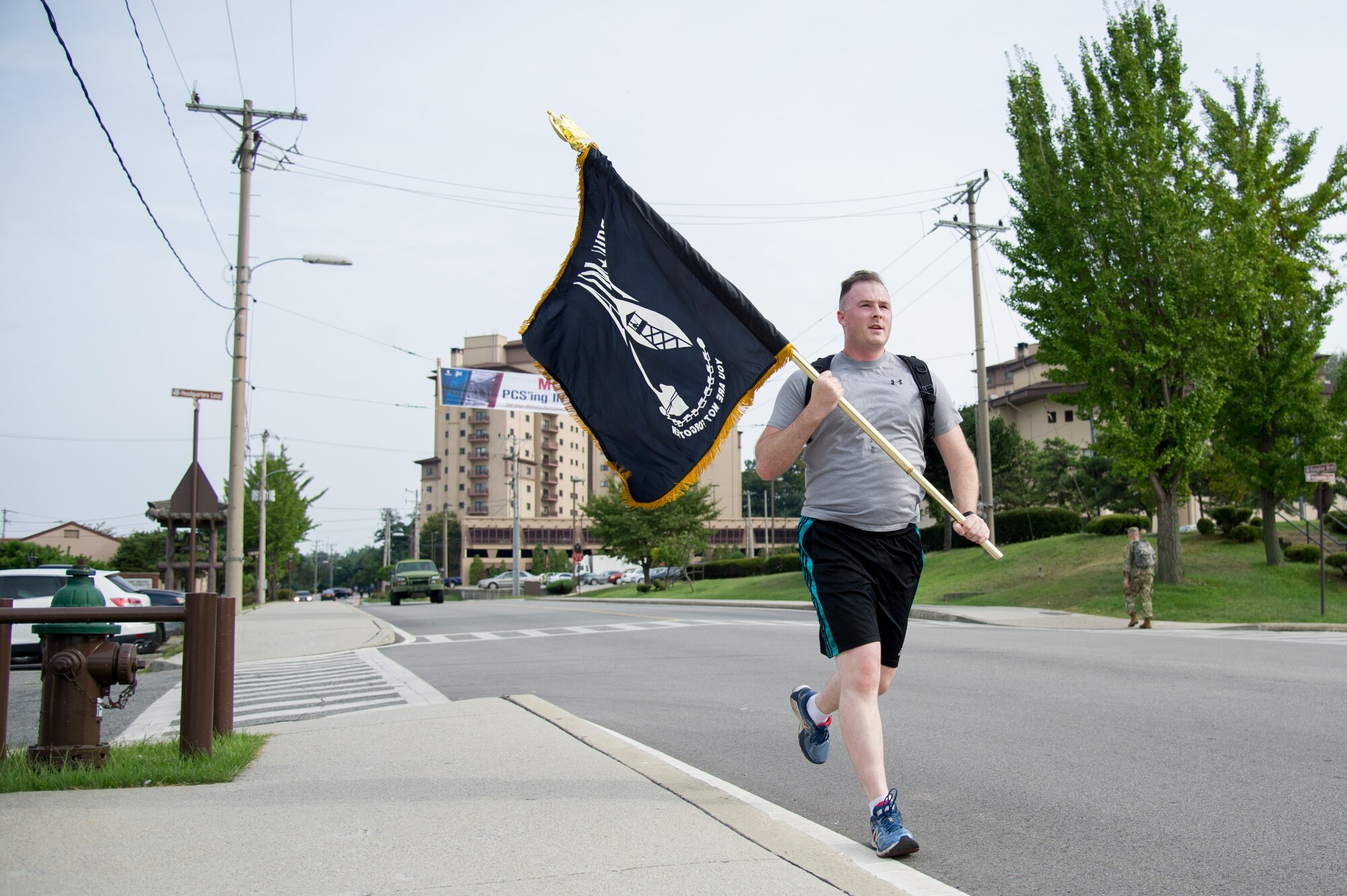 U.S. Air Force Staff Sgt. Joel, 6th Intelligence Squadron, carries a flag during a POW/MIA 24 hour remembrance run at Osan Air Base, Republic of Korea, Sept. 15, 2016. The flag stayed in motion for 24 hours to pay respect and honor those service members are that are still missing. (U.S. Air Force photo by Staff Sgt. Jonathan Steffen)