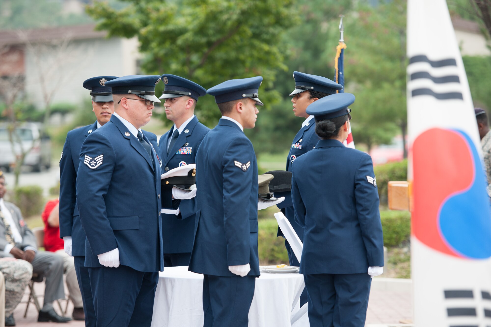 51st Fighter Wing Honor Guard members carry the hats of different branches of the U.S. military to a POW/MIA table during a POW/MIA memorial closing ceremony at Osan Air Base, Republic of Korea, Sept. 16, 2016. The table represents the U.S. government’s everlasting concern and responsibility for the still-missing service members. (U.S. Air Force photo by Staff Sgt. Jonathan Steffen)