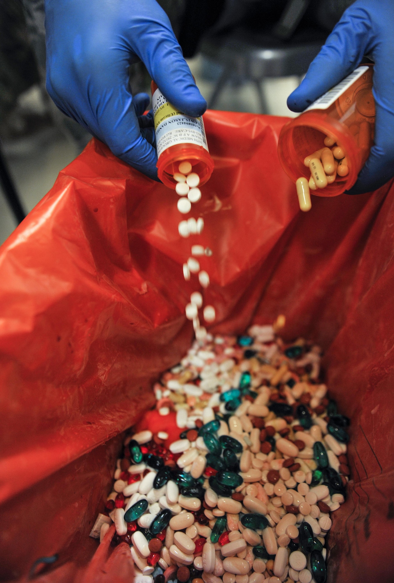 Airman 1st Class Nicholas Murphy, 18th Security Forces Squadron response force member, pours expired medicines into a collection box during the Drug Take-Back Day event at the 18th Medical Group, Sept. 23, 2016, at Kadena Air Base, Japan. During the event, Kadena received approximately 156 pounds in unused or expired prescribed medications to turn in at designated locations for proper disposal. (U.S. Air Force photo by Naoto Anazawa)