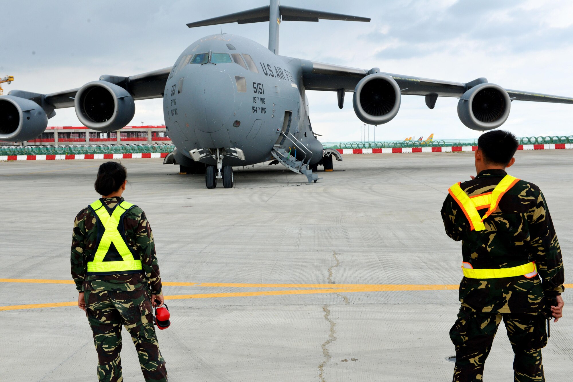 Members of the Philippines Air Force observe a U.S. Air Force C-17 at Mactan Air Base, Philippines, Sept. 24, 2016. The military members were in Mactan in support of U.S. Pacific Command’s ongoing Air Contingent mission. The goal of the rotation is for Philippine military and civilian leaders to work with their U.S. counterparts to improve airlift capabilities across the spectrum of military operations and to solidify long-standing relationships in the region. (U.S. Air Force photo by Capt. Mark Lazane)