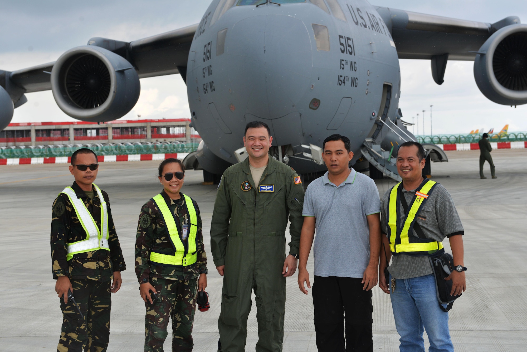 Members of the Philippines Air Force stand with U.S. Air Force Maj. Brian Barba, Joint U.S. Military Assistance Group Chief of Air Operations, in front of a U.S. Air Force C-17 at Mactan Air Base, Philippines, Sept. 24, 2016. The military members were in Mactan in support of U.S. Pacific Command’s ongoing Air Contingent mission. The goal of the rotation is for Philippine military and civilian leaders to work with their U.S. counterparts to improve airlift capabilities across the spectrum of military operations and to solidify long-standing relationships in the region. (U.S. Air Force photo by Capt. Mark Lazane)