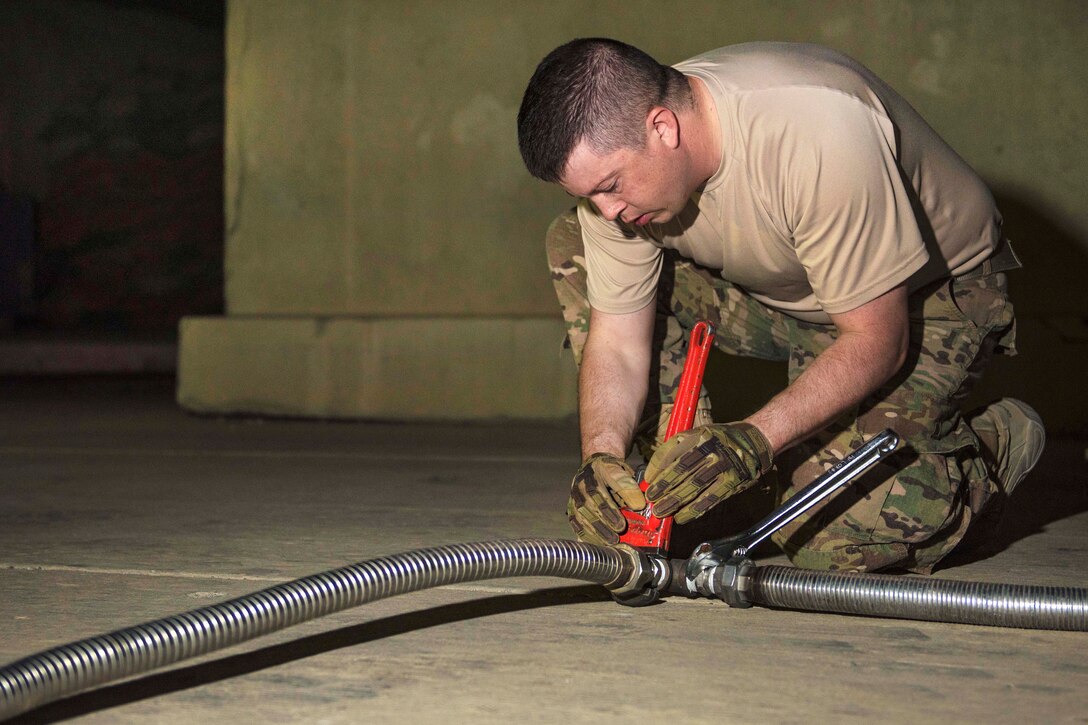 Air Force Staff Sgt. Nathan Knight adjusts a liquid oxygen tank hose at Bagram Airfield, Afghanistan, Sept. 14, 2016. Knight is a cryogenics supervisor assigned to the 455th Expeditionary Logistics Readiness Squadron. Air Force photo by Senior Airman Justyn M. Freeman 
