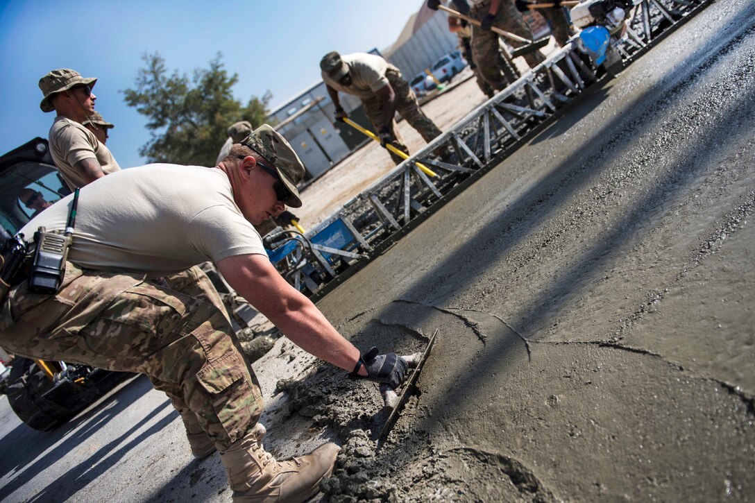 Air Force Staff Sgt. Casey Pentecost smooths concrete at Bagram Airfield, Afghanistan, Sept. 19, 2016. Pentecost is a pavements and equipment specialist assigned to the 455th Expeditionary Civil Engineer Squadron. Air Force photo by Senior Airman Justyn M. Freeman