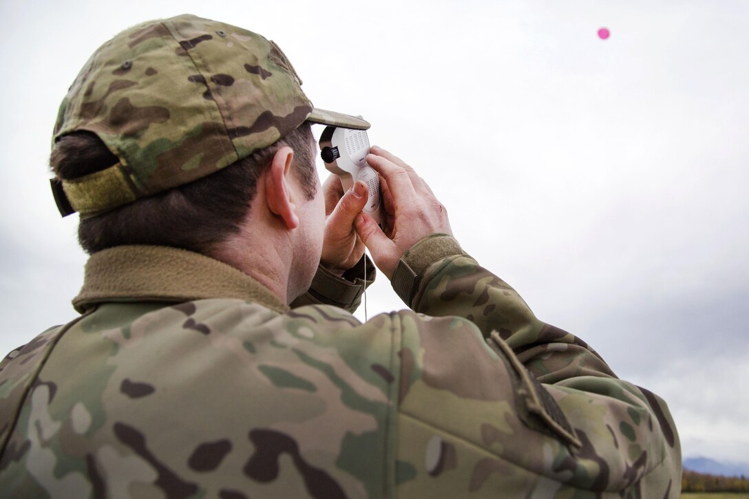 Air Force Staff Sgt. Nicolas Strickler tracks the flight path of a weather balloon while measuring wind velocity at Joint Base Elmendorf-Richardson, Alaska, Sept. 20, 2016. Strickler is assigned to the 3rd Air Support Operations Squadron. Air Force photo by Alejandro Pena
