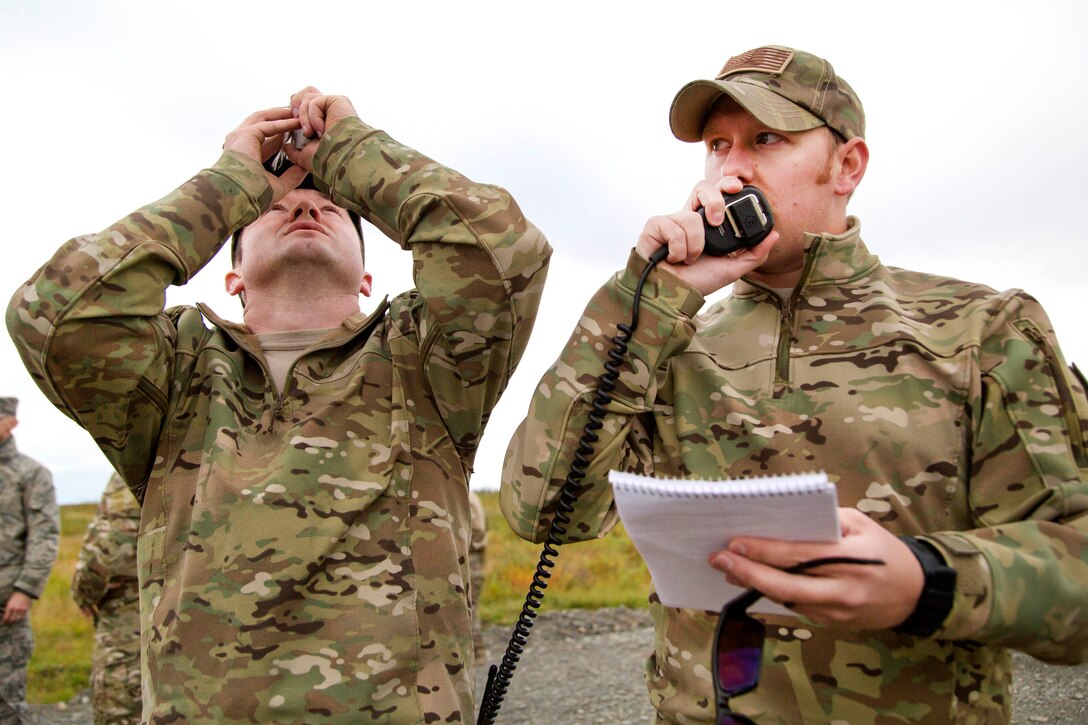 Air Force Staff Sgt. Nicolas Strickler, left, tracks the flight path of a weather balloon while Air Force Capt. Michael Spanogle relays that information to inbound C-17 Globemaster III pilots at Joint Base Elmendorf-Richardson, Alaska, Sept. 20, 2016. Strickler is assigned to the 3rd Air Support Operations Squadron. Spanogle is assigned the 517th Airlift Squadron. Air Force photo by Alejandro Pena