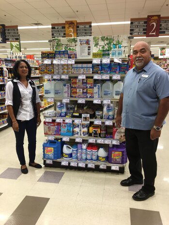 MCAS Yuma Installation Emergency Manager (right) stands in front of a display in the Commissary. The display highlights items needed for an emergency kit. Courtesy photo by MCAS Yuma