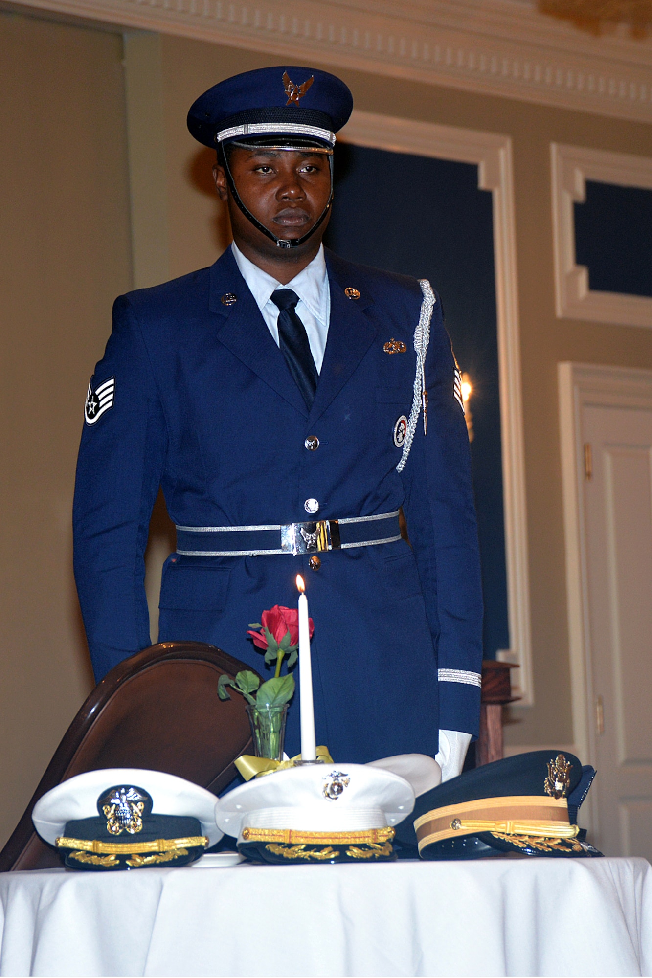 Staff Sgt. Porter Smith-Munroe, an Offutt Honor Guardsman, performs a Missing Man Table ceremony during a POW and MIA remembrance luncheon held at the Patriot Club at Offutt Air Force Base, Nebraska Sept. 16. (U.S. Air Force photo by Kendra Williams)