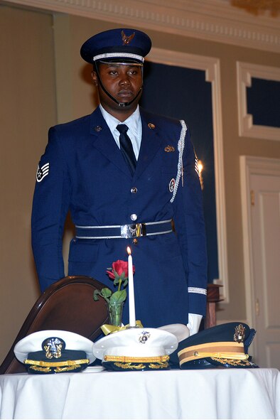 Staff Sgt. Porter Smith-Munroe, an Offutt Honor Guardsman, performs a Missing Man Table ceremony during a POW and MIA remembrance luncheon held at the Patriot Club at Offutt Air Force Base, Nebraska Sept. 16. (U.S. Air Force photo by Kendra Williams)