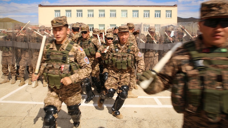 Mongolian Armed Forces soldiers and Mongolian National Police practice dispersing a crowd during a simulated riot for the Non-Lethal Executive Seminar 2016 at the Five Hills Training Area, Mongolia, Sept. 19, 2016. Mongolian soldiers and National Police rehearsed various riot control formations. Non-lethal weapons are designed to incapacitate equipment and personnel while minimizing fatalities and permanent injury to personnel, and undesired collateral damage to property.