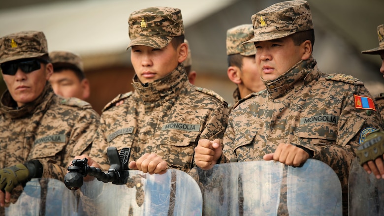 Mongolian Armed Forces soldiers prepare for a simulated riot during Non-Lethal Executive Seminar 2016 at the Five Hills Training Area, Mongolia, Sept. 19, 2016. Mongolian soldiers and National Police rehearsed various riot control formations. Non-lethal weapons are designed to incapacitate equipment and personnel while minimizing fatalities and permanent injury to personnel, and undesired collateral damage to property.