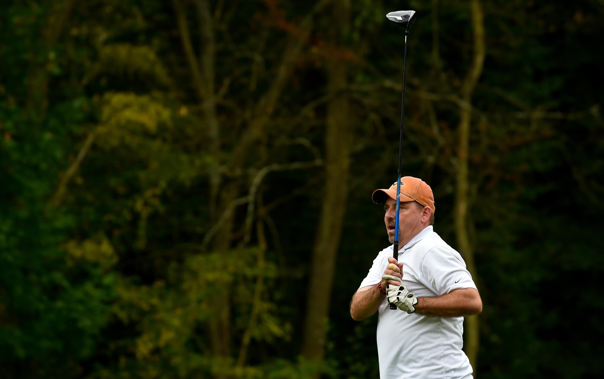 A retired service member watches his golf ball travel across the green during the Army and Air Force Challenge golf tournament Sept. 18, 2016, at Rheinblick Golf Course, Wiesbaden, Germany.  Airmen took home the trophy for the third year in a row, with a score of 39-33. (U.S. Air Force photo by Senior Airman Nicole Keim)