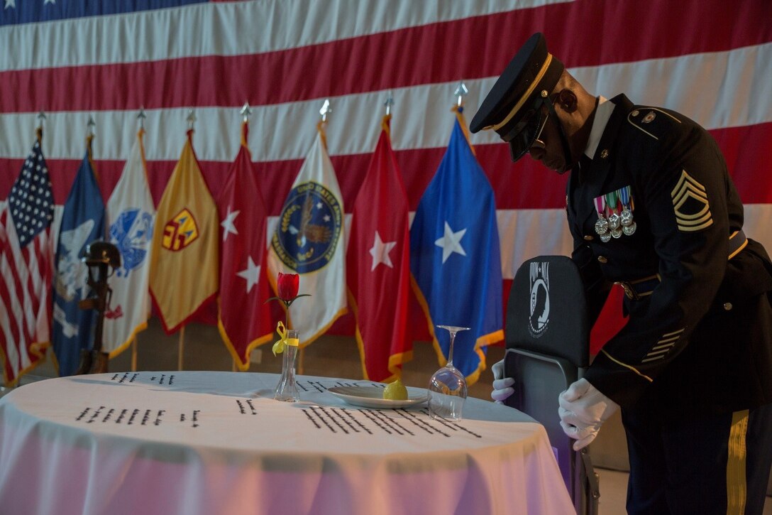 Master Sgt. Winzer Jimerson, Color Sergeant for the 377th Theater Sustainment Command Honor Guard, United States Army Reserve, sets an empty chair at the Fallen Soldiers Table during the Gold Star Mothers and Family Day celebration at Naval Air Station Joint Reserve Base New Orleans, Sept. 25, 2016. The table is set to honor fallen, missing and imprisoned military service members, and serves as a symbol of their sacrifice. (U.S. Marine Corps photo by Cpl. Melissa Martens/ Released)