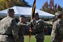 Watched by outgoing 63rd Regional Support Command commanding general Maj. Gen. Nickolas Tooliatos (left) and Command Sgt. Maj. Ted DeWitt (right), command sergeant major, 63rd RSC, Maj. Gen. Peter Lennon (second left), deputy commanding general (support), U.S. Army Reserve Command, passes the 63rd RSC guidon to new 63rd RSC commanding general Maj. Gen. Brian Alvin, during a change of command ceremony, Sept. 25, Moffett Field, Mountain View, Calif. (U.S. Army Reserve photo by Capt. Alun Thomas)