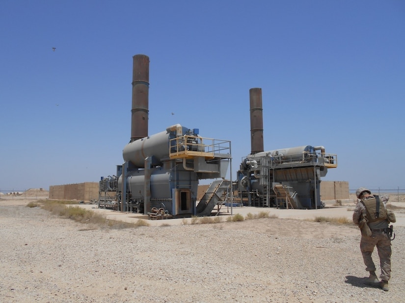 A Marine inspects incinerators at Camp Al Taqaddum, Iraq.  Incinerators have been implemented throughout the U.S. Army Central area of operations as a more eco-friendly solution to disposing of waste. U.S. forces are readily deployable to anywhere on the planet and have the capability to set up operations under very harsh conditions to meet the required objectives. A set of environmental guidelines is followed to minimize initial impact and alternatives that are more protective of human health and the environment are constantly implemented as operations transition from initial deployment into sustainment.