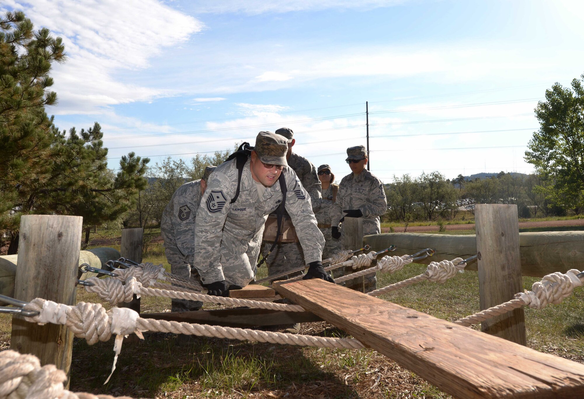 Master Sgt. Paul Lanoue, the first sergeant assigned to the 28th Force Support Squadron, attempts to cross an obstacle during a Leadership Reaction Course at the South Dakota National Guard West Camp Rapid training facility, Rapid City, S.D., Sept. 15, 2016. The exercise, consisting of more than 10 obstacles, required critical and strategic thinking as well as teamwork to surpass each obstacle. (U.S. Air Force photo by Airman 1st Class Donald C. Knechtel)