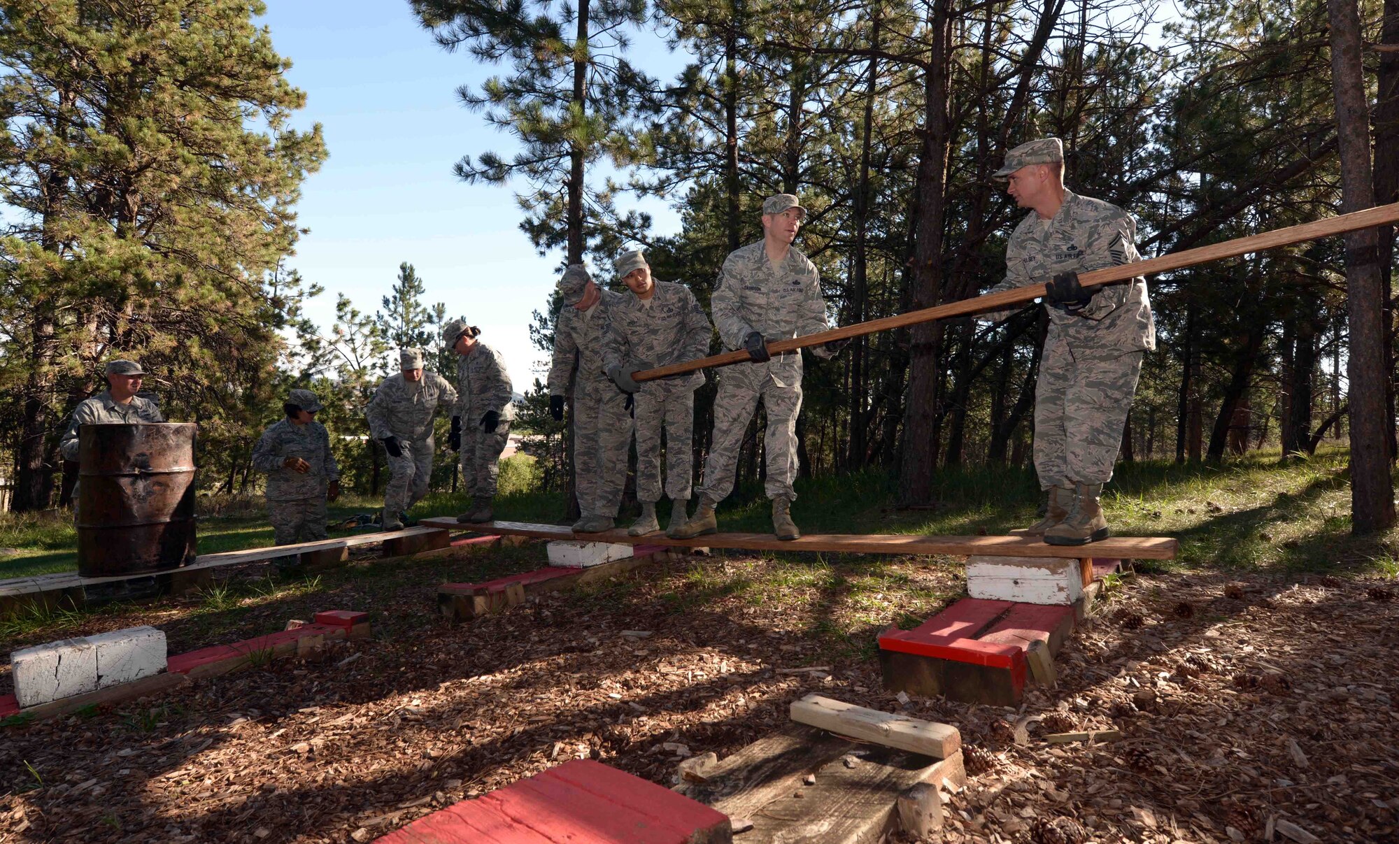First sergeants from Ellsworth Air Force Base, S.D., attempt to cross an obstacle during a Leadership Reaction Course at the South Dakota National Guard West Camp Rapid training facility, Rapid City, Sept. 15, 2016. This challenge, along with a few others, demanded a great deal of trust among the participants in order to achieve the given task. (U.S. Air Force photo by Airman 1st Class Donald C. Knechtel)