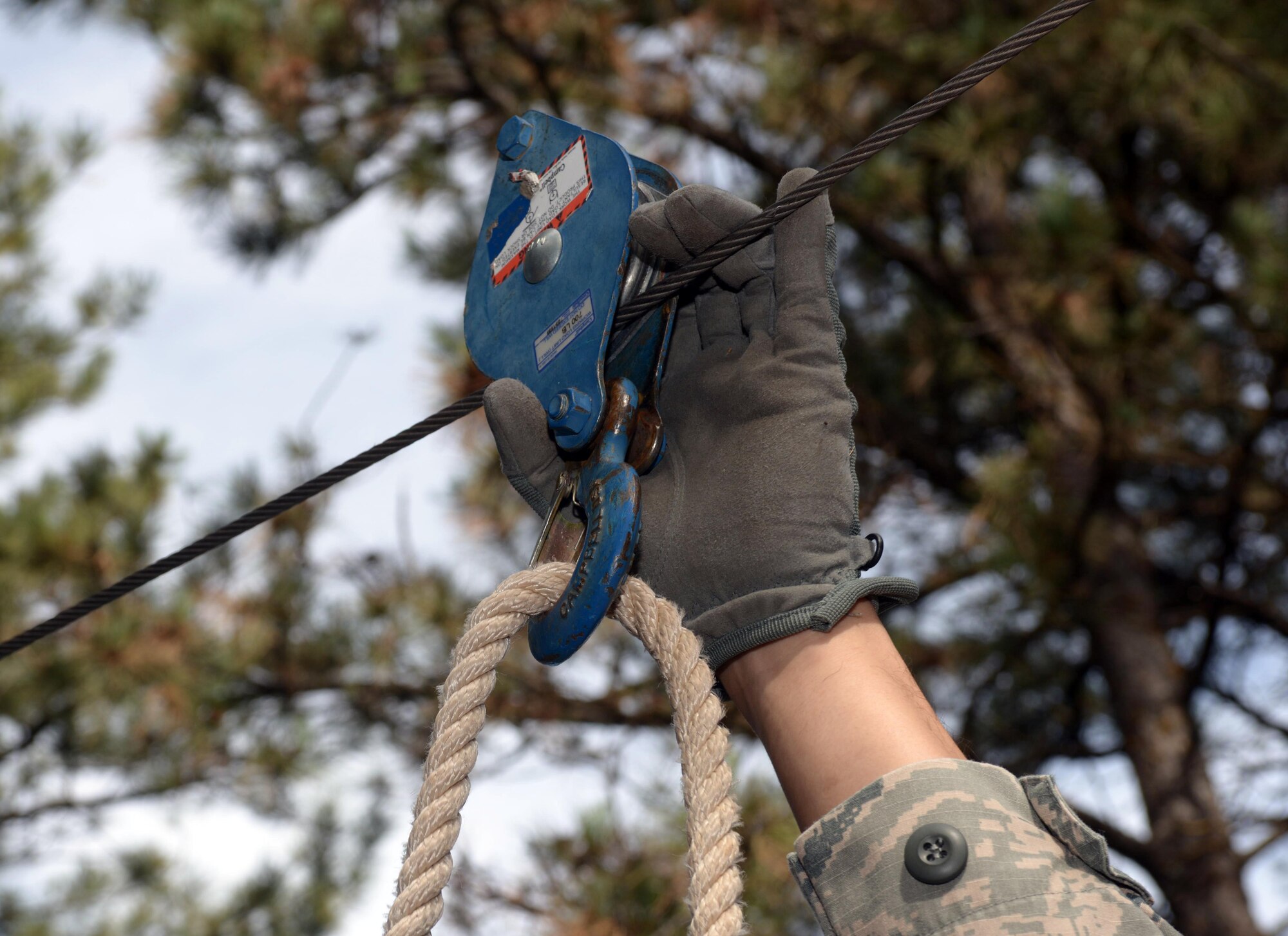 Master Sgt. Nathan Landry, the first sergeant assigned to the 28th Medical Group, fastens a rope for the next obstacle in the Leadership Reaction Course at the South Dakota National Guard West Camp Rapid training facility, Rapid City, S.D., Sept. 15, 2016. The zip line provided a means to transport equipment and personnel. Once the equipment was secured, participants hoisted themselves across in order to complete the obstacle. (U.S. Air Force photo by Airman 1st Class Donald C. Knechtel)