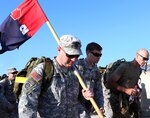 Sgt. 1st Class Joshua Partner, with Headquarters and Headquarters Company, 2nd Infantry Brigade Combat Team, 28th Infantry Division, carries the unit’s guidon while rucking 28 miles during the March for the Fallen ruck march held on Camp Bondsteel, Kosovo. The event is meant to honor those who have died in service to the country and mirrors an event held at Fort Indiantown Gap, Pa., home station for many units of the brigade. 