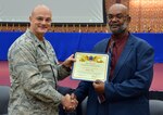 Defense Logistics Agency Aviation Commander Air Force Brig. Gen. Allan Day presents a certificate of appreciation to Bobby Tyler during the Air Force’s 69th birthday ceremony held at the Lotts Center on Defense Supply Center Richmond, Virginia, Sept. 22, 2016. Tyler, a Richmond native, was a sergeant who served in the Air Force from 1969 until 1971. He was a guest speaker for the ceremony. 