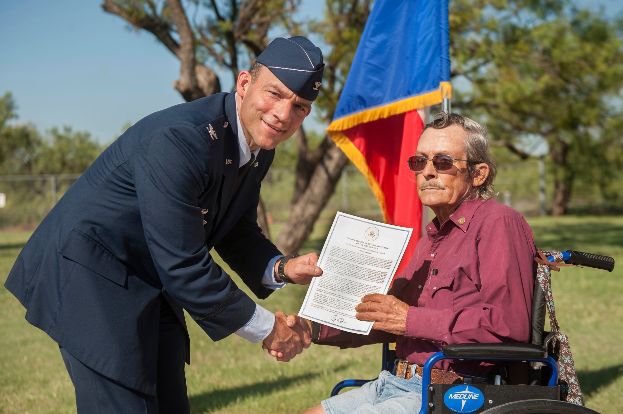U.S. Air Force Col. David Benson, 7th Bomb Wing commander, presents a presidential proclamation to Darrell North at the Dyess Memorial Center, Abilene, Texas, Sept. 23, 2016. More than 70 participating Vietnam veterans were presented lapel pins provided by the United States of America Vietnam War Commemoration for their service during the Vietnam War era. (U.S. Air Force Photo by Airman 1st Class Rebecca Van Syoc)