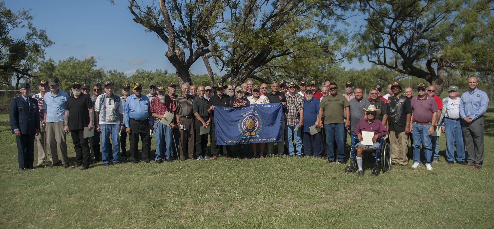 A group of Vietnam War veterans from various branches of service stand for a group photo at the Dyess Memorial Center, Abilene, Texas, Sept. 23, 2016. More than 70 participating Vietnam veterans were presented lapel pins provided by the United States of America Vietnam War Commemoration for their service during the Vietnam War era. (U.S. Air Force Photo by Airman 1st Class Rebecca Van Syoc)
