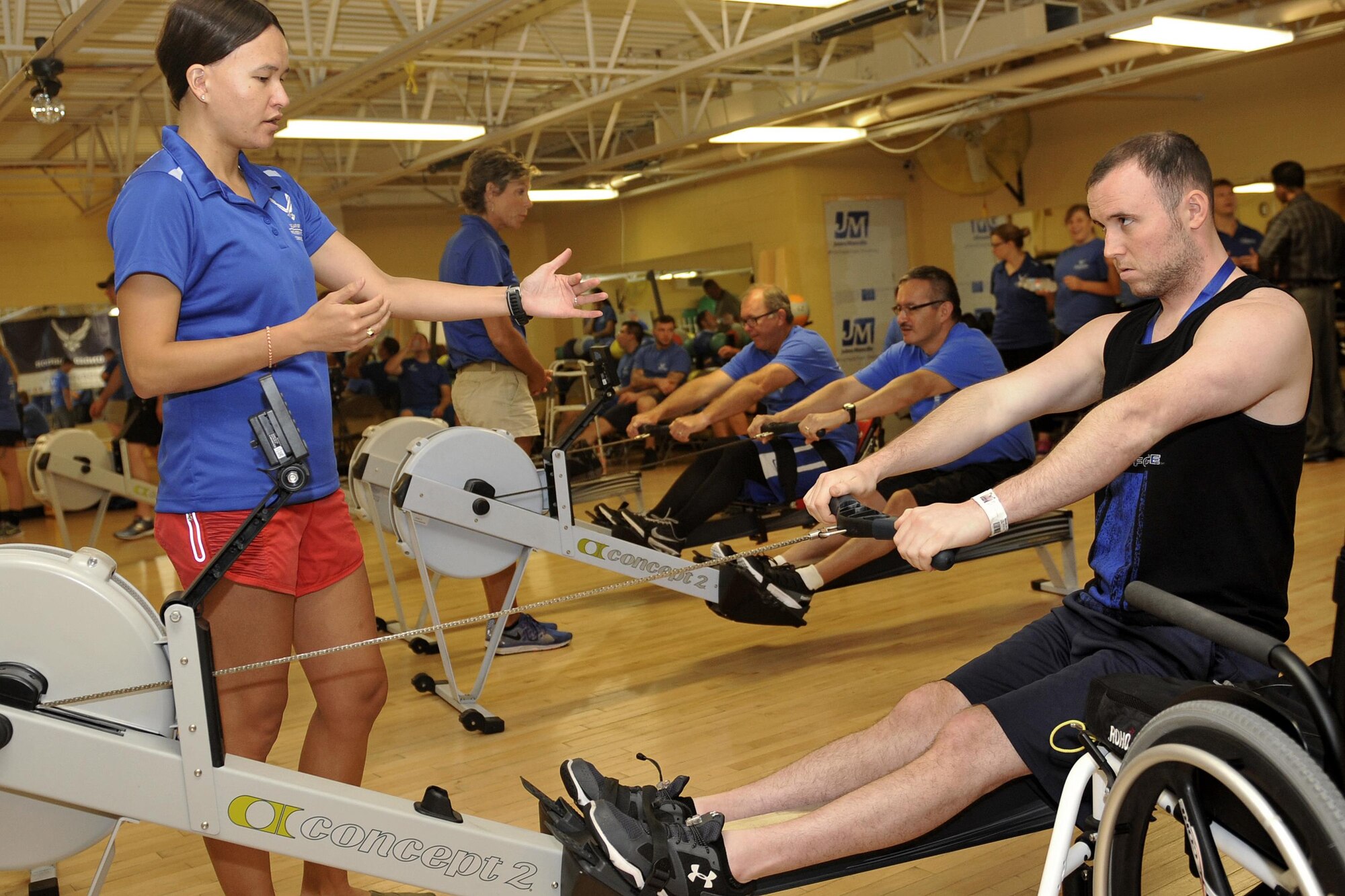 U.S. Air Force Senior Airman Scott Brown follows close instruction from Coach Katy Milton during the rowing exercise. Wounded warriors members from across the country participated in a special camp focused on recovery. More than 120 participated in hopes to aid with their healing process with events like archery, swimming, basketball and more at Offutt Air Force Base, Nebraska, Sept. 17 - 23. (U.S. Air Force photo by Jeff W. Gates)