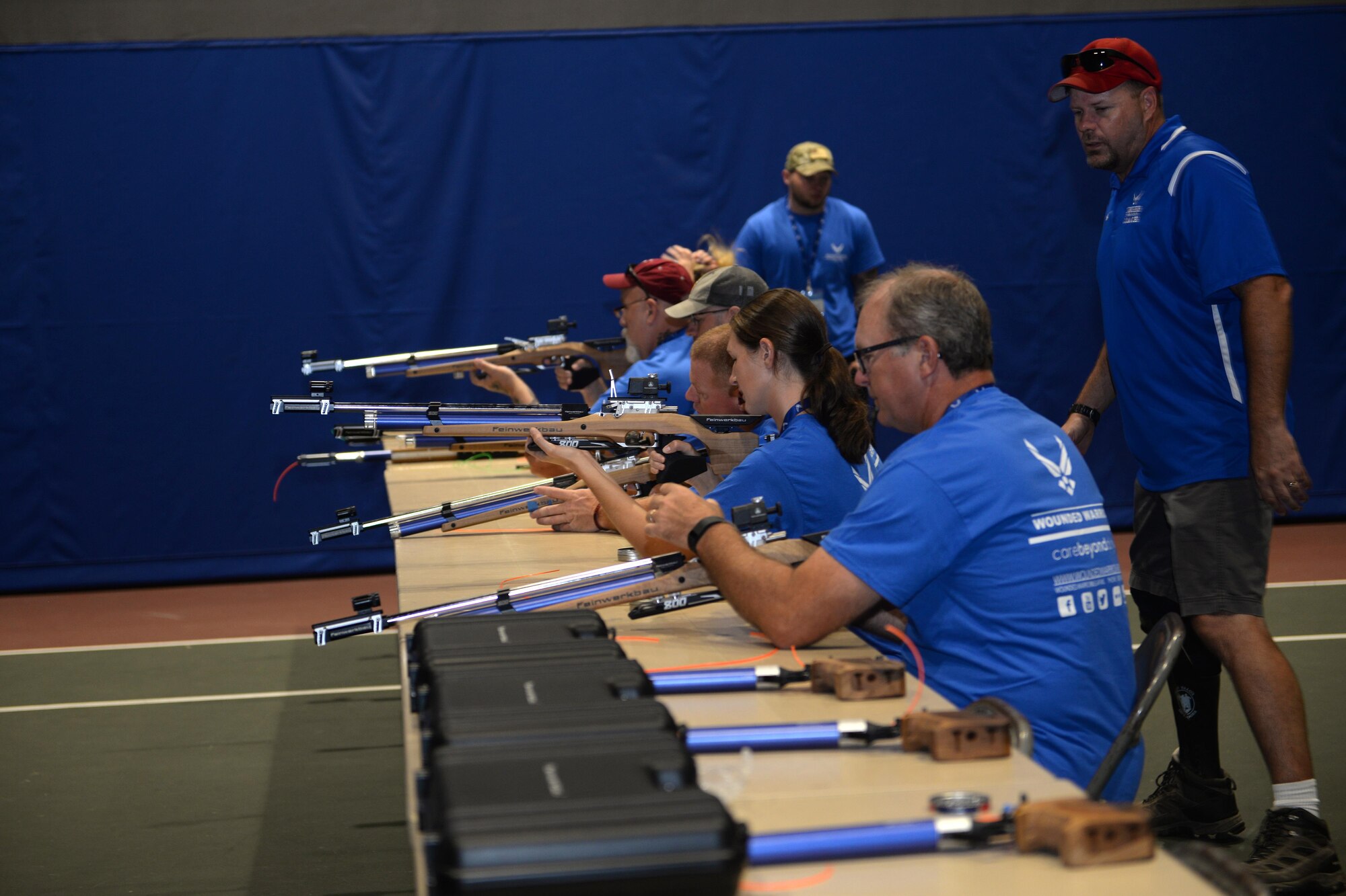 Coach Dan Duitsman, works with Wounded Warriors as they practice their shooting skills at the Offutt Field House. Wounded warriors members from across the country participated in a special camp focused on recovery. More than 120 participated in hopes to aid with their healing process with events like archery, swimming, basketball and more at Offutt Air Force Base, Nebraska, Sept. 17 - 23. (U.S. Air Force photo by Jeff W. Gates)