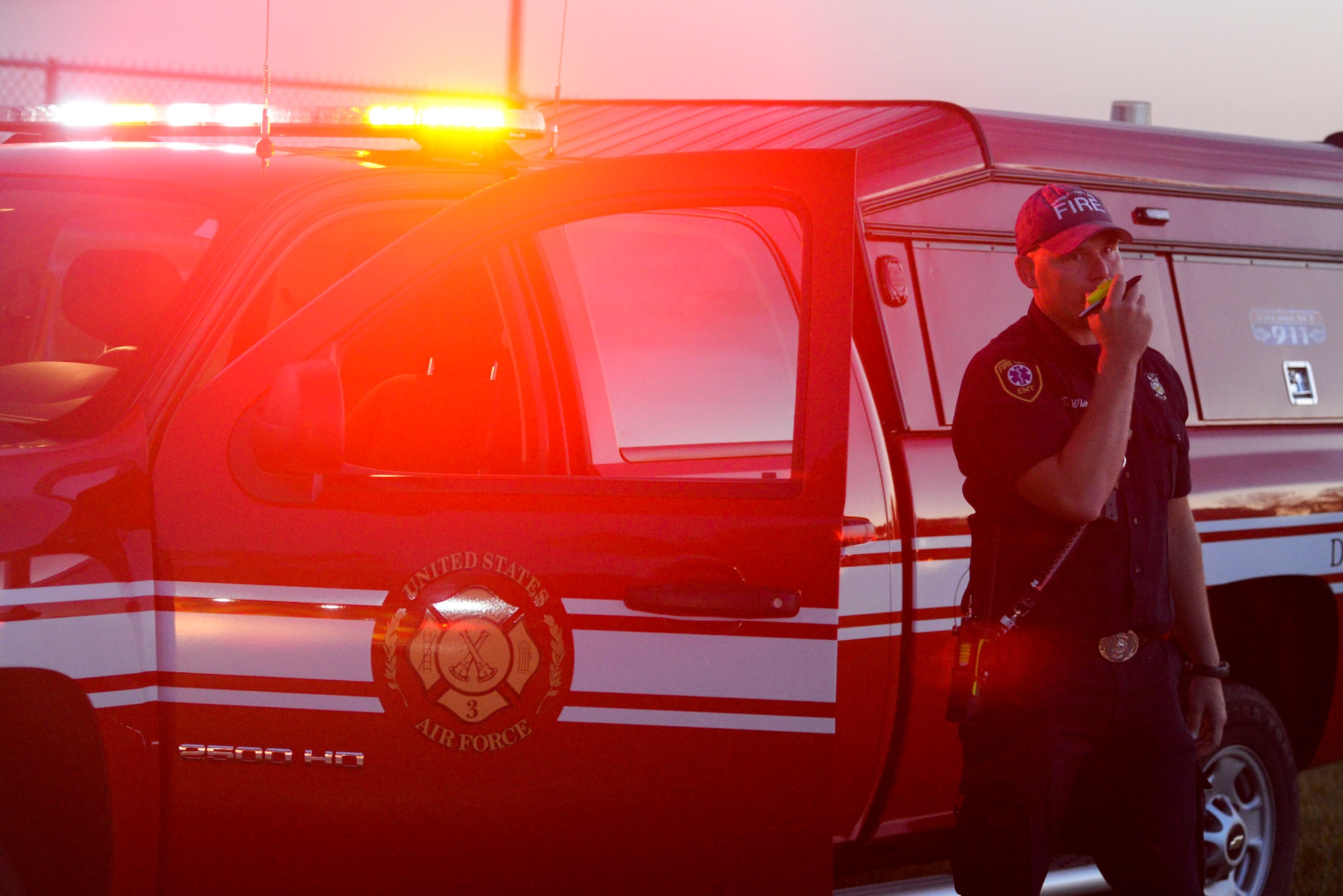 Duane White, 788th Civil Engineer Squadron district chief, radios other firefighters during a training exercise at their training burn pit, Sept. 19, 2016 at Wright-Patterson Air Force Base, Ohio. Crews put out two different kinds of aircraft fires in addition to conducting searches for victims as part of their training. (U.S. Air Force photo by Wesley Farnsworth)