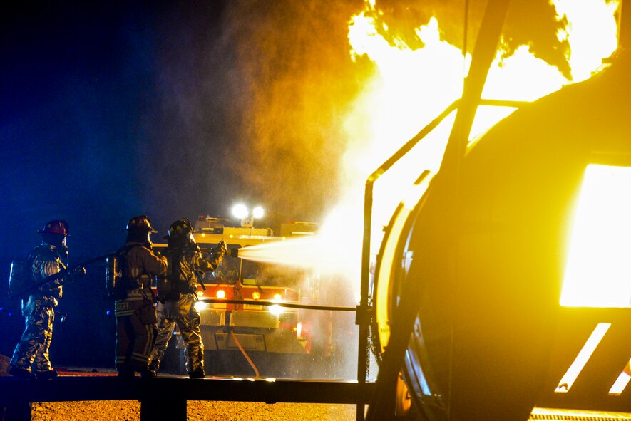 Firefighters from the 788th Civil Engineer Squadron fire department fight an internal aircraft fuselage fire at their training burn pit, Sept. 19, 2016 at Wright-Patterson Air Force Base, Ohio. Crews also fought to put out an external aircraft fire in addition to conducting searches for victims as part of their training. (U.S. Air Force photo by Wesley Farnsworth) 