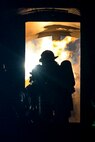 Firefighters from the 788th Civil Engineer Squadron fire department fight an internal aircraft fuselage fire at their training burn pit, Sept. 19, 2016 at Wright-Patterson Air Force Base, Ohio. Crews also fought to put out an external aircraft fire in addition to conducting searches for victims as part of their training. (U.S. Air Force photo by Wesley Farnsworth) 