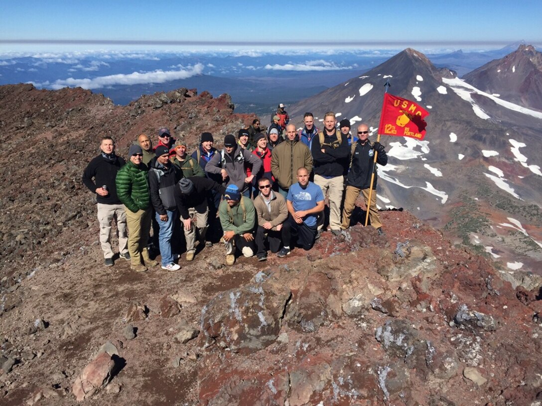 Marines from Recruiting Station Portland pose for a picture at the peak of Three Sisters, a complex of three volcanic peaks of the Cascade Volcanic Arc and the Cascade Mountain Range of Oregon. The highest peak of Three Sisters is 10,358 feet and it experiences frequent snow and occasional rainfall, with extreme temperature differences between seasons. (Photo Courtesy of the RS Portland SgtMaj Facebook Page)