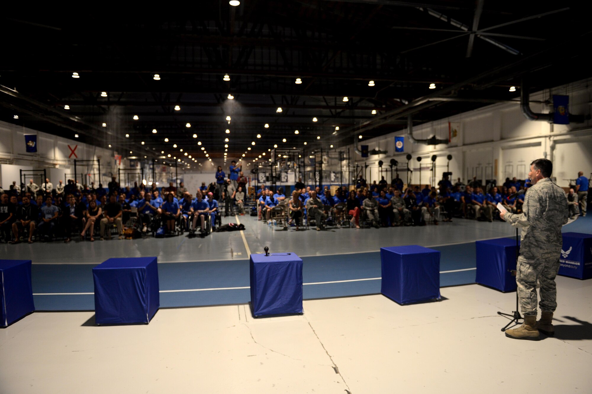 U.S. Air Force Col. Marty Reynolds, commander of the 55th Wing, welcomes patrons at the opening ceremony for the Offutt Wounded Warriors Care Event. Wounded warrior members from across the country participated in a special camp focused on recovery. More than 120 participated in hopes to aid with their healing process with events like archery, swimming, basketball and more at Offutt Air Force Base, Nebraska, Sept. 17 - 23. (U.S. Air Force photo by Jeff W. Gates)