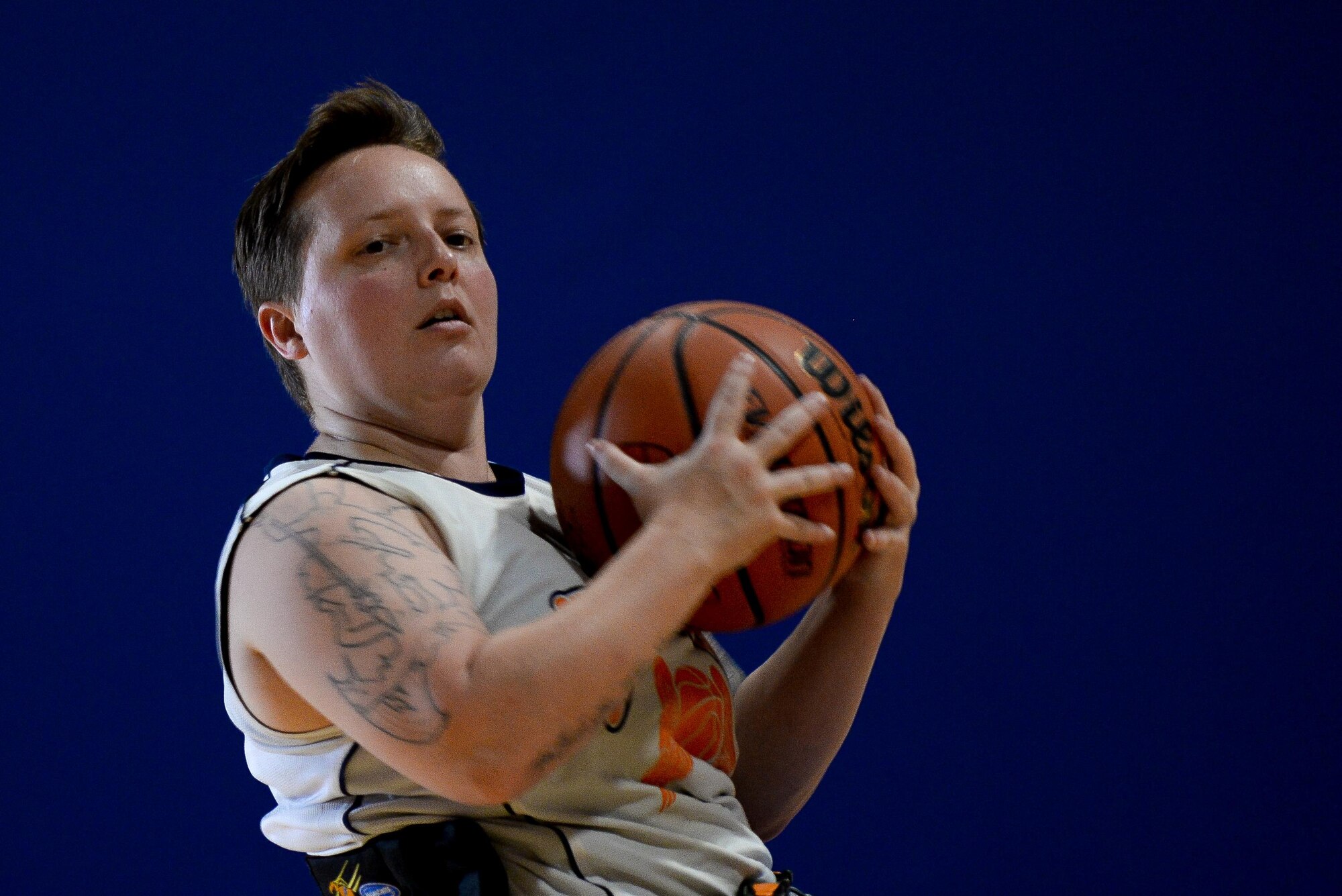 Jamie Biviano, wounded warrior, catches a ball during seated basketball in the Offutt Field House at Offutt Air Force Base, Neb., Sept. 21, 2016. Wounded warriors is an adaptive sports competition for wounded, ill and injured service members and veterans. (U.S. Air Force photo by Zachary Hada)