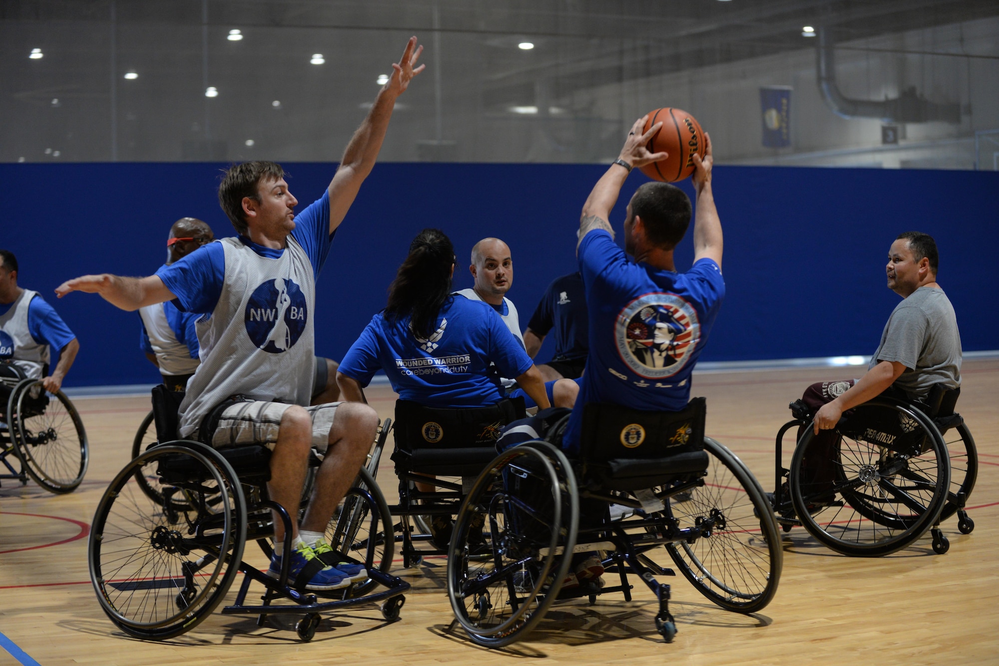 Wounded Warriors play seated basketball in the Offutt Field House at Offutt Air Force Base, Neb., Sept. 21, 2016. The base hosted a four day long training camp for wounded warriors to train in preparation for their yearly competition in June. (U.S. Air Force photo by Zachary Hada)