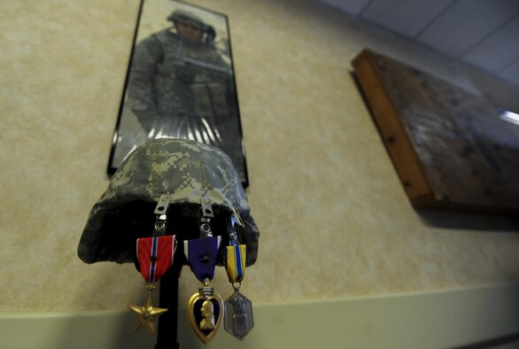 Senior Airman Michael Buras’s medals hang in a memorial within the new Buras EOD Facility at Nellis Air Force Base, Nev., Sept. 21. In honor of Buras’ ultimate sacrifice, his memory will always be celebrated by those who step foot in the new EOD facility. (U.S. Air Force photo by Airman 1st Class Kevin Tanenbaum/Released)