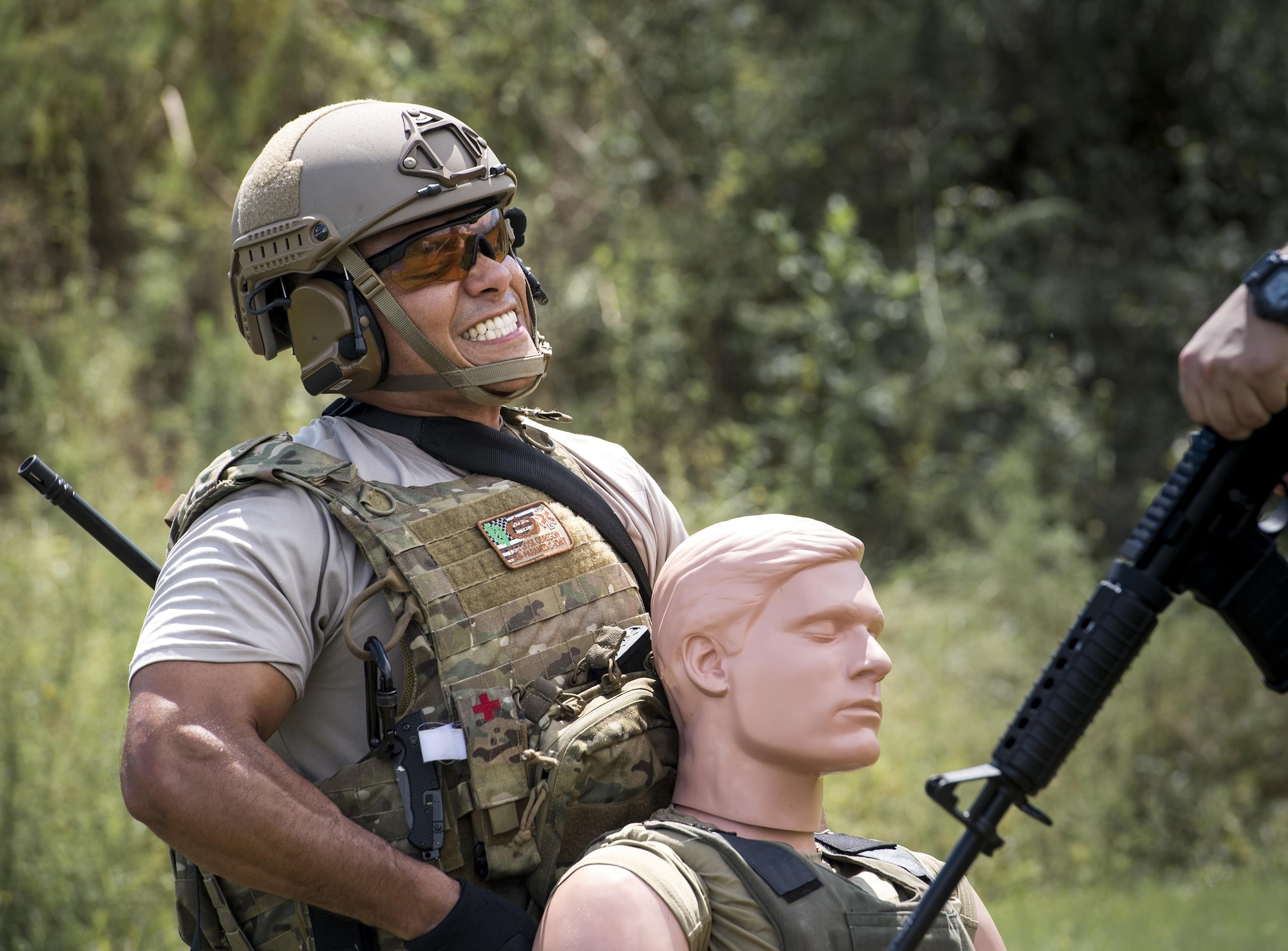 U.S. Air Force Tech. Sgt. Jose Obregon, 347th Operations Support Squadron independent duty medical technician-paramedic, tightens a strap to secure a simulated patient to his chest for evacuation during a tactical combat casualty care course, Sept. 22, 2016, in Okeechobee, Fla. During the scenarios, the course participants tested new equipment and techniques to see what would work best with their individual missions. (U.S. Air Force photo by Staff Sgt. Ryan Callaghan)