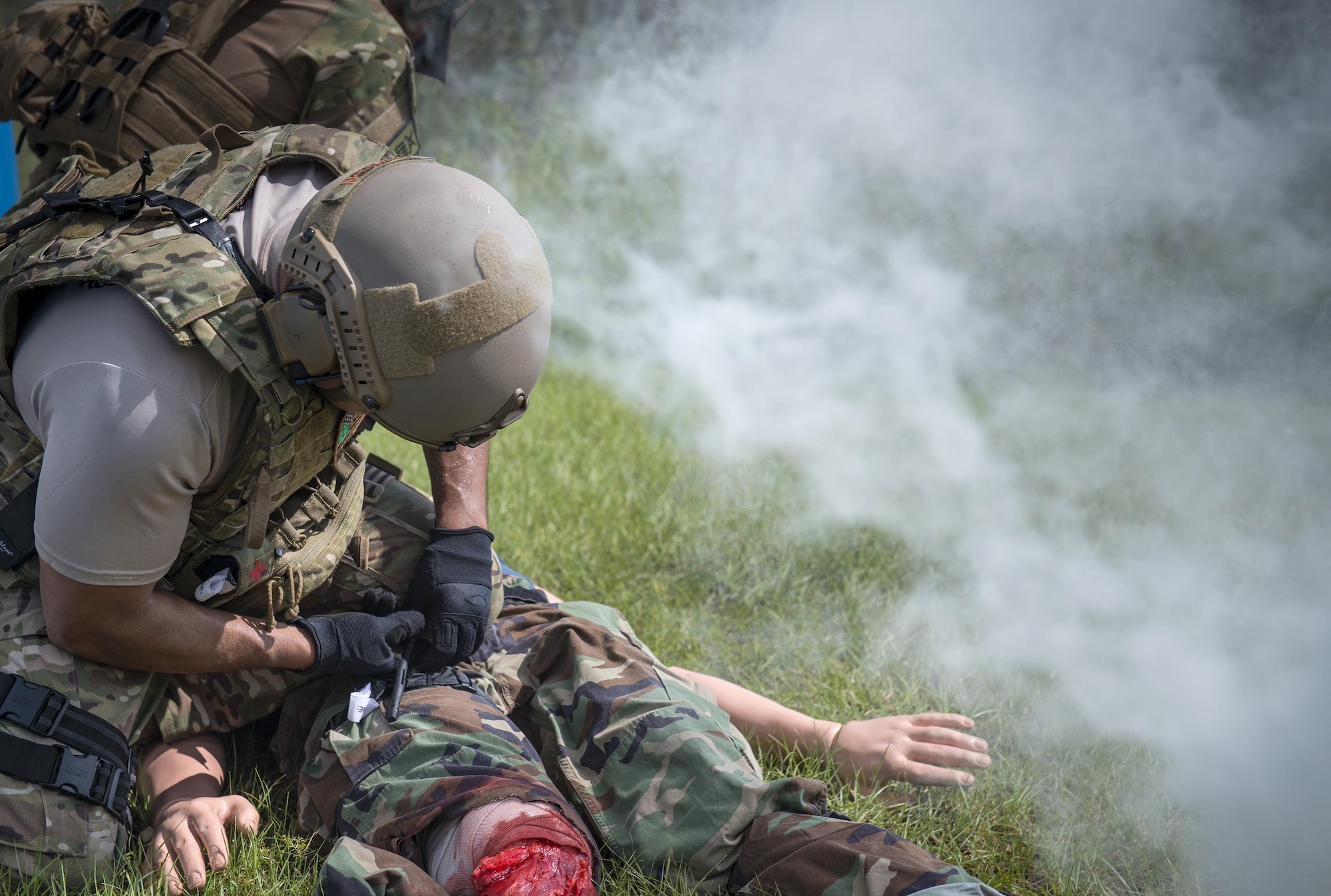 U.S. Air Force Tech. Sgt. Jose Obregon, 347th Operations Support Squadron independent duty medical technician-paramedic, applies a tourniquet to a simulated patient during a tactical combat casualty care course, Sept. 22, 2016, in Okeechobee, Fla. In order to simulate realistic human flesh, the instructors used pork meat and fake blood in conjunction with the mannequins. (U.S. Air Force photo by Staff Sgt. Ryan Callaghan)