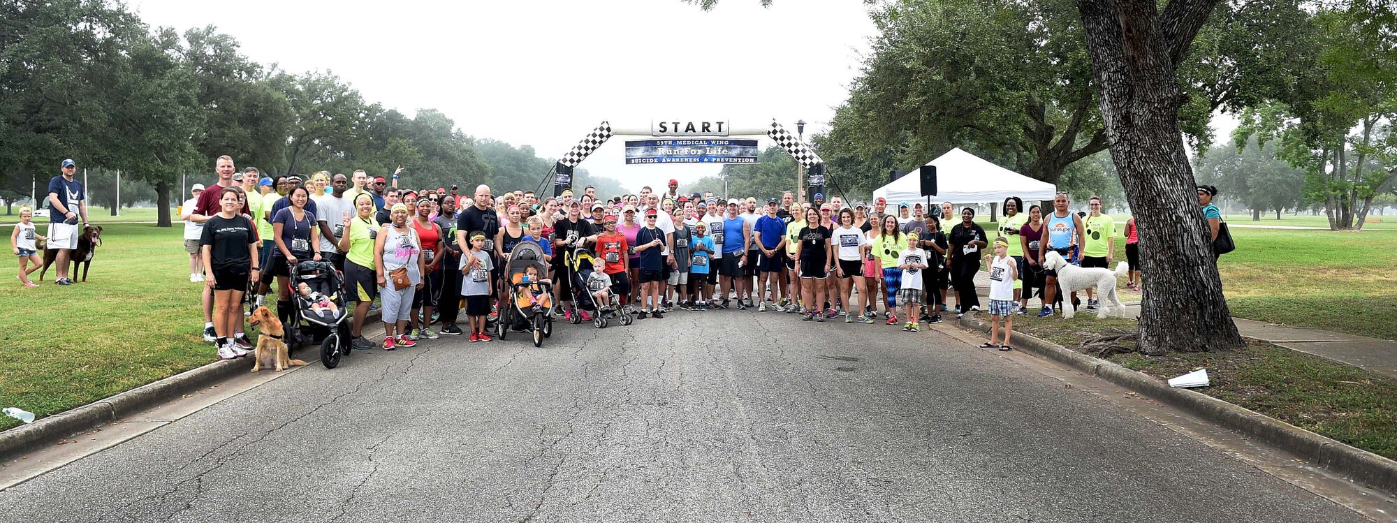 Airmen, civilians and their families participating in the 4th Annual 5K Run for Life event pose for a group photo at Heritage Park on Joint Base San Antonio-Randolph, Texas, Sept. 24, 2016. Hosted by the 59th Medical Wing, the annual event aims to raise awareness of suicide and suicide prevention. (U.S. Air Force photo/Staff Sgt. Jerilyn Quintanilla)