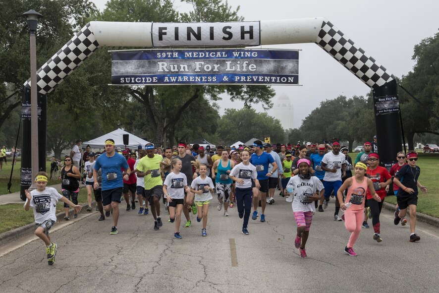 Runners who are participating in the 4th Annual 5K Run for Life event take off from the starting line at Heritage Park on Joint Base San Antonio-Randolph, Texas, Sept. 24, 2016. Nearly 260 Airmen, civilians and their families participated in the event, which was sponsored by the 59th Medical Wing. (U.S. Air Force photo/Senior Airman Stormy Archer)
