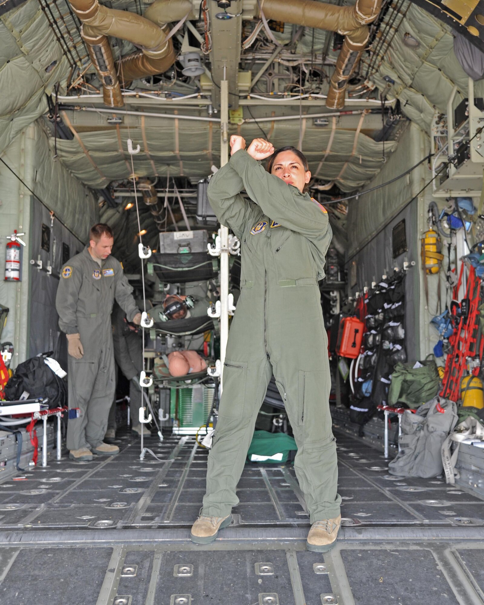Captain Maritza Ruiz, flight nurse, 45 Aeromedical Evacuation Squadron, MacDill AFB, Florida, controls the loading of patients into a C-130 during a recent AE training exercise. Recently the 45 AES teamed up with the 302 Airlift Wing, Peterson AFB, Colorado for a three-day training mission. (U.S. Air Force photo by Tech. Sgt. Peter Dean)