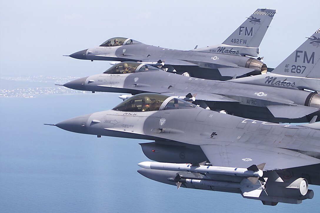 482nd Fighter Wing / 93rd Fighter Squadron closeup of a threeship formation of Lockheed F-16C Fighting Falcons carrying Aim-120 and Aim-9 air-to-air missiles. The aircraft are based at Homestead Air Reserve Station flying near the Southern Flordia coastline. (Photo by: MSgt Joe Cupido, 4th Combat Camera)