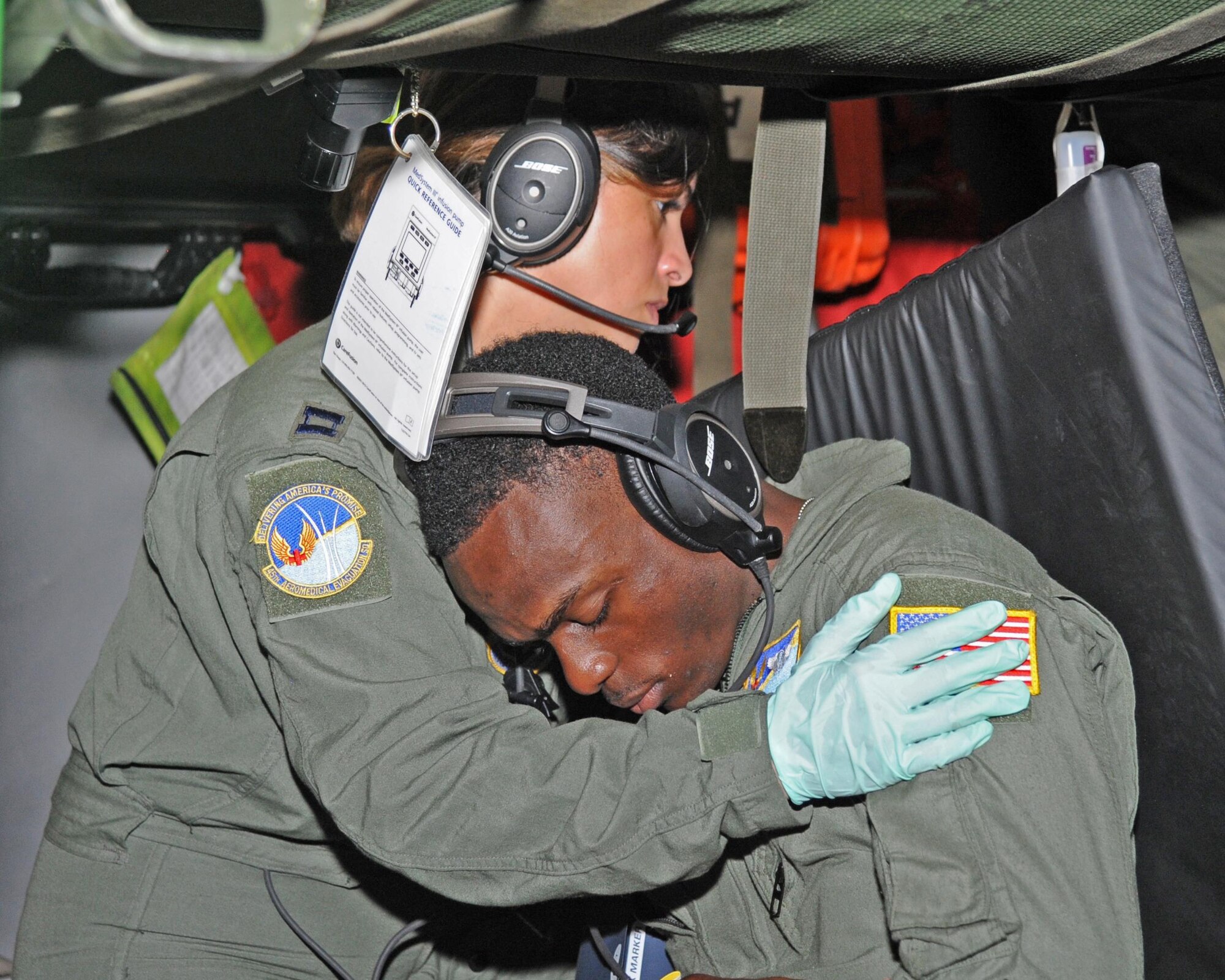 Captain Maritza Ruiz, flight nurse, 45 Aeromedical Evacuation Squadron, MacDill AFB, Florida, administers medical care to a simulated patient played by Senior Airman Dojaniee Hutchinson, medical technician, 45AES. Recently the 45 AES teamed up with the 302 Airlift Wing, Peterson AFB, Colorado for a three-day training mission. (U.S. Air Force photo by Tech. Sgt. Peter Dean)