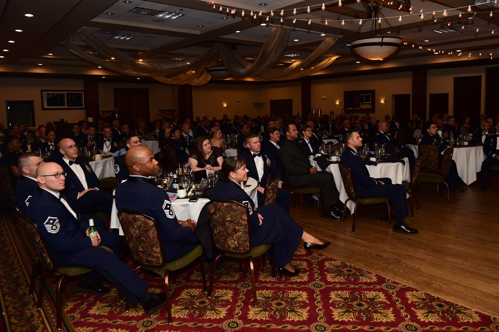 Team Buckley listens to former Chief Master Sgt. of the Air Force Frederick J. "Jim" Finch speak during a senior NCO induction ceremony Sept. 23, 2016, Heritage Eagle Bend Golf Course in Aurora, Colo. The ceremony is a long-standing Air Force tradition that recognizes those who have reached the rank of master sergeant. (U.S. Air Force photo by Airman 1st Class Gabrielle Spradling/Released)